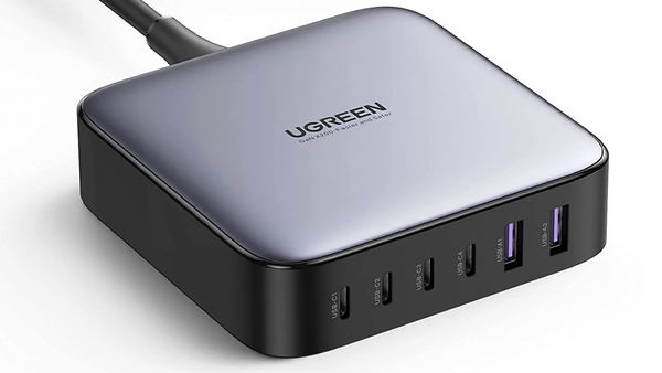 Ugreen desktop charging station with multiple USB ports and cables arranged against white background.