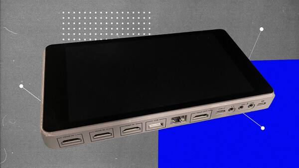Illustration of a tablet device with multiple USB ports along its edge against a split gray and blue background.