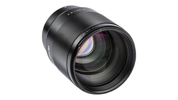 Fast telephoto lens with large aperture and internal focus mechanism on white background.