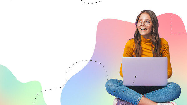 Woman in yellow shirt sitting cross-legged with laptop, smiling against colorful gradient background.