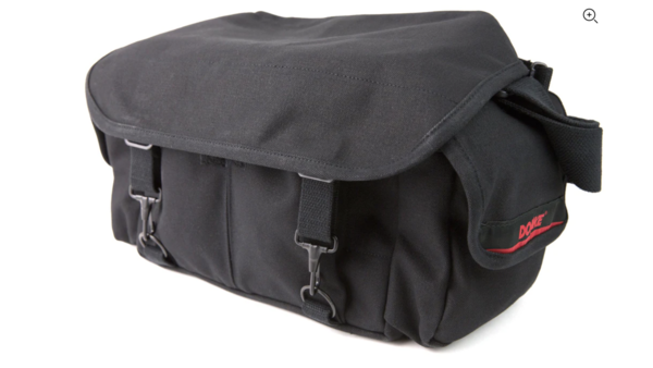 Black canvas camera bag with flap closure and side pockets against a white background.