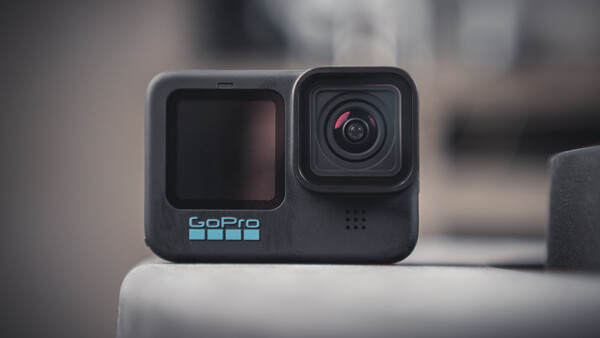 GoPro Hero 11 Black action camera with dual front and rear displays mounted on white surface.