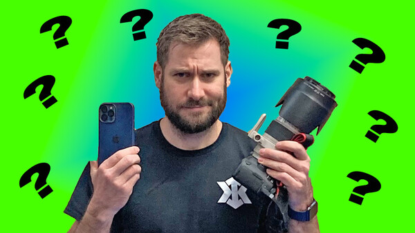 Man holding smartphone and camera lens against colorful gradient background with question marks.