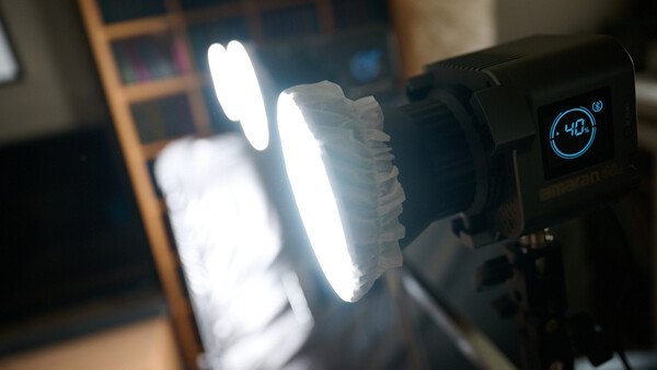 LED panel light with digital display showing color temperature setting during product demonstration.