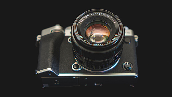 Vintage rangefinder camera with fast prime lens mounted, shot against dark background from above.