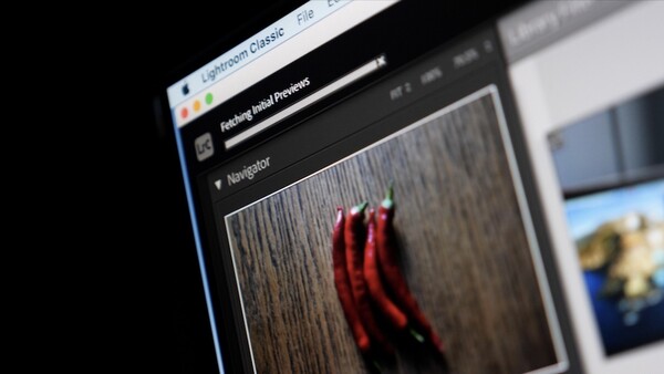 Screenshot of photo editing software showing red chili peppers on a wooden surface in the preview panel.