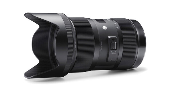 Black telephoto zoom lens with lens hood attached, shown at an angle against a white background.