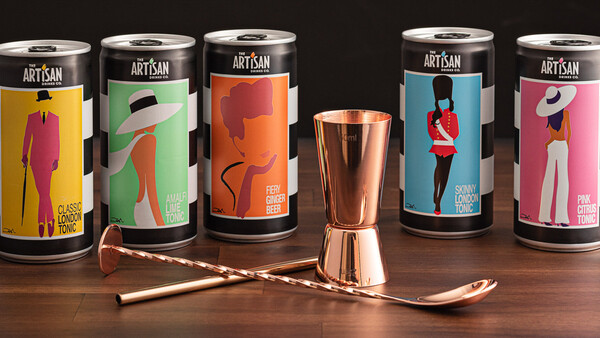 Artisan beverage packaging with colorful illustrated designs displayed with copper barware.
