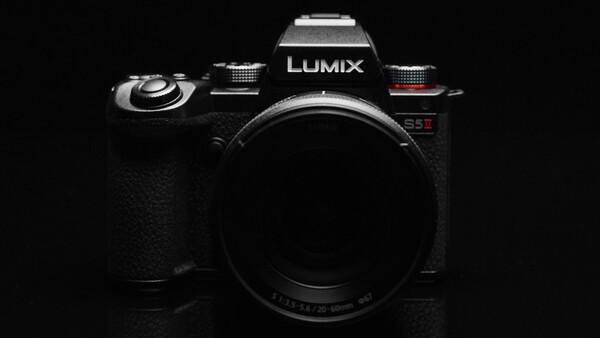 Panasonic Lumix camera body against black background, front-facing view.