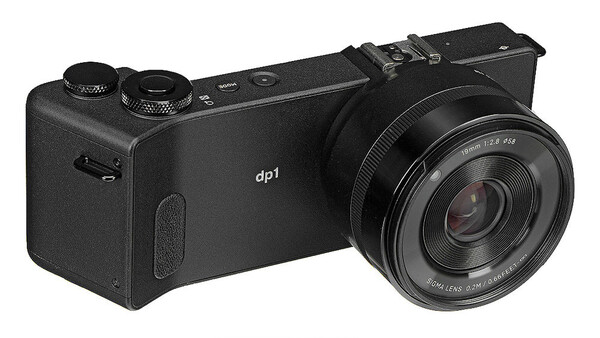 The Sigma dp1 Merrill compact camera with fixed prime lens, shown at a three-quarter angle against a white background.