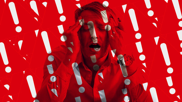Person's face overlaid with red and gray geometric shapes against a bright red background with white exclamation marks and circles.