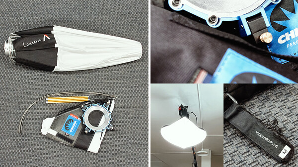 Photography lighting equipment including a softbox, LED panel, reflector, and cables laid out on a gray surface.