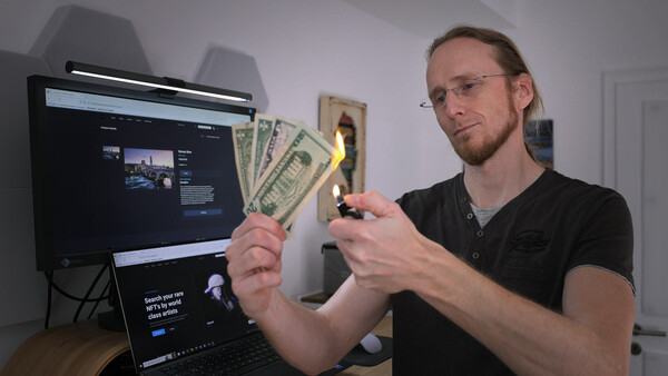 Man holding burning dollar bills in front of computer monitors displaying financial content.