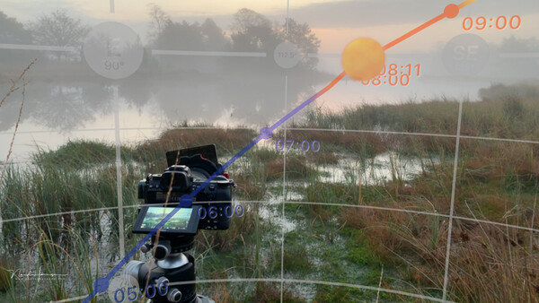 Camera mounted on a tripod overlooking a misty wetland with time-lapse visualization overlay.