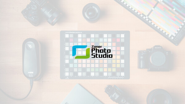 Logo for Zoner Photo Studio displayed on a tablet surrounded by photography equipment.