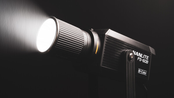 Vanlite FS-60B LED light fixture mounted on stand with bright white spotlight beam against dark background.