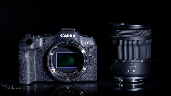 Canon EOS R5 mirrorless camera body with Canon RF 15-30mm lens against black background.
