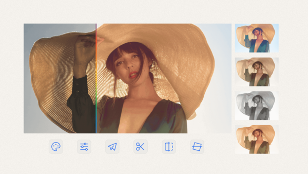 Portrait of woman wearing oversized straw hat and brown vest against blue sky.
