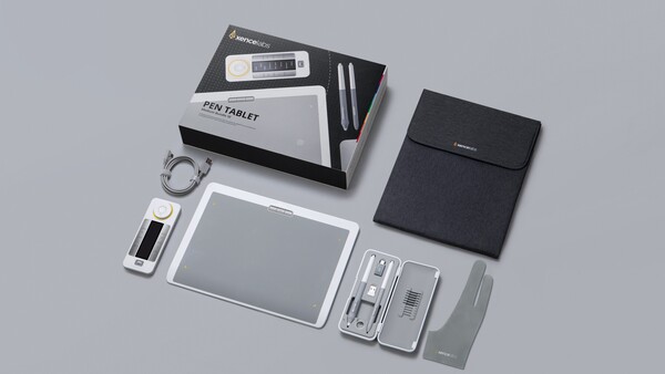 Flat lay of a pen tablet and accessories arranged on a neutral gray surface.