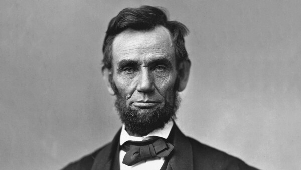 Black and white portrait photograph of a bearded man in formal attire with bow tie.
