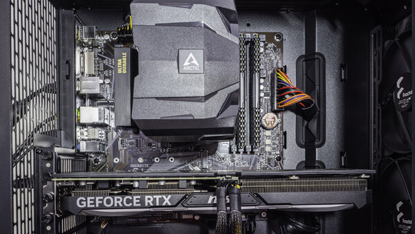 Interior view of a computer case showing motherboard, GPU, and CPU cooler installation.