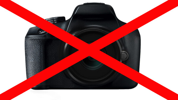 Black DSLR camera with red X overlay symbol indicating prohibition or rejection.