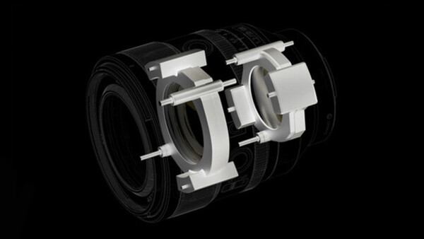 Cutaway illustration of a camera lens showing internal optical elements and mechanical components.