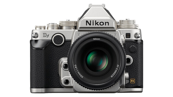 Nikon Df DSLR camera with silver top plate and black body, featuring a standard prime lens with green optical elements visible.