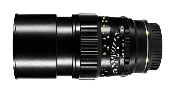 Black telephoto lens with manual focus ring and aperture scale markings.