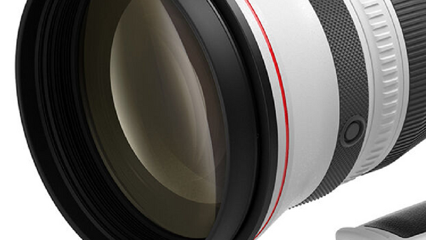 Close-up cross-section of a camera lens showing internal glass elements and mechanical components.