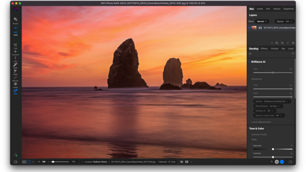 Screenshot of photo editing software displaying a sunset seascape with silhouetted rock formations.