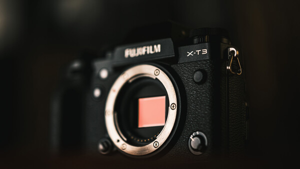 Fujifilm X-T3 camera body with open shutter, showing the sensor and mirror box against a dark background.