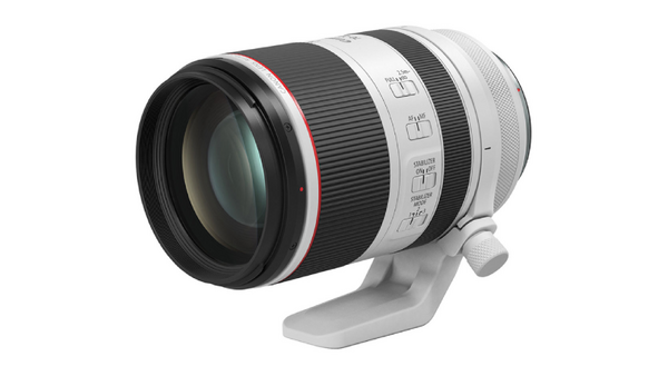 White and black telephoto lens with built-in tripod collar and focus ring controls.