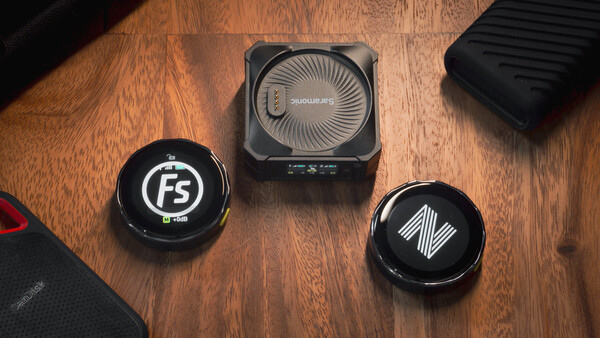 Three circular lens filters and a square camera cooling device arranged on a wooden surface.