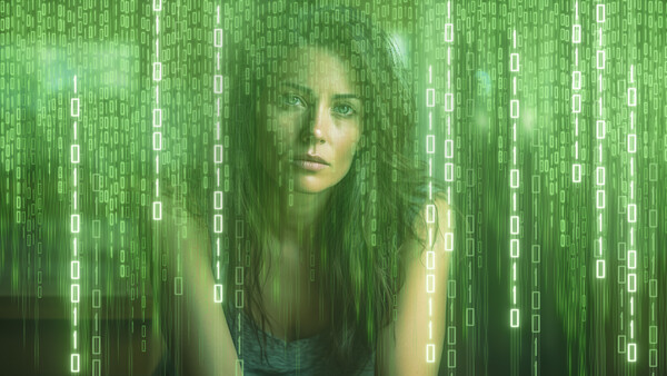 Woman's face overlaid with cascading green digital code and binary digits.