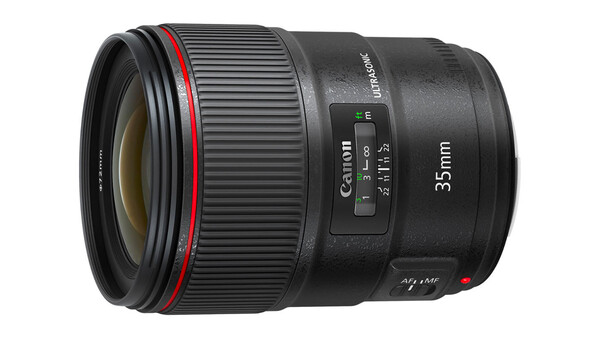 Canon 35mm prime lens with red ring and autofocus mechanism visible on black barrel.