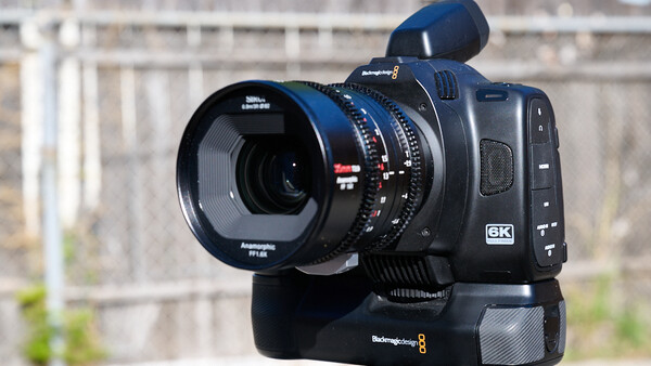 Blackmagic 6K cinema camera with anamorphic lens and shoulder rig mounted outdoors.