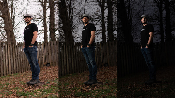 Man in black shirt and jeans standing in wooded area with wooden fence, shown in three progressive lighting conditions from natural to dark.