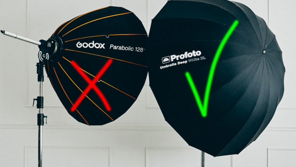 Two large parabolic umbrellas mounted on a light stand, marked with red and green X and checkmark symbols respectively.