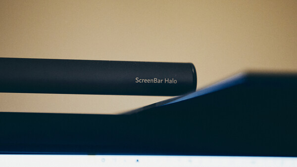 LG ScreenBar Halo monitor light with curved design mounted above display against neutral background.