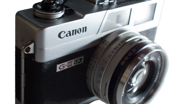 Canon Canonet G-III QL17 rangefinder camera with fixed lens, featuring black body and silver top plate.