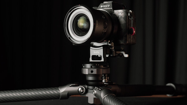 Sony mirrorless camera mounted on tripod with ring light modifier attached to lens.