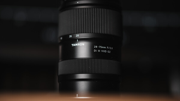 Tamron 28-75mm F/2.8 Di III VXD G3 lens mounted vertically against dark background.