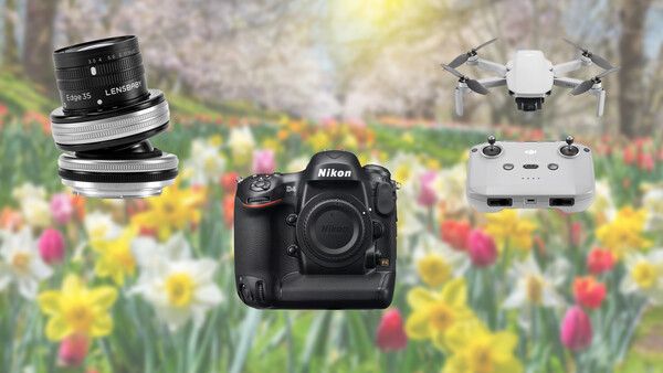 Nikon DSLR camera body with interchangeable lenses and a compact drone against a blurred floral background.