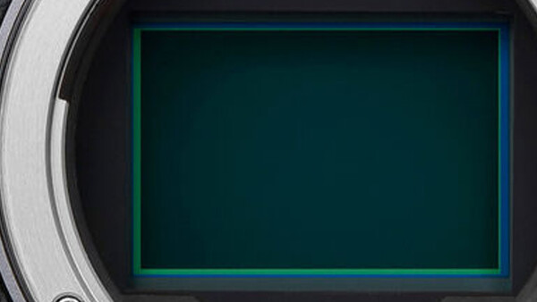 Camera viewfinder display with glowing teal frame border on dark background.
