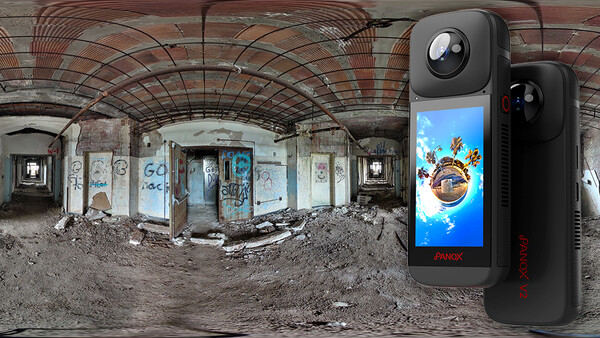 360-degree camera device displayed next to an expansive panoramic photograph of an abandoned, deteriorating interior space.