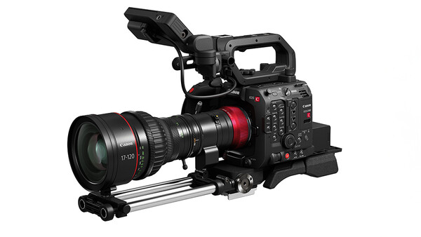 Professional cinema camera with red accents mounted on a support rig with telephoto lens attached.