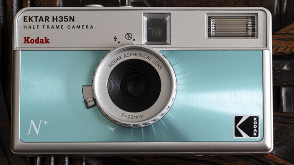 Kodak Ektar H35N half-frame camera with light blue body and chrome lens.