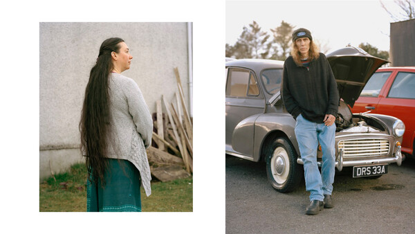 Woman with long dark hair wearing a cream cardigan and teal skirt stands in profile against a white wall.