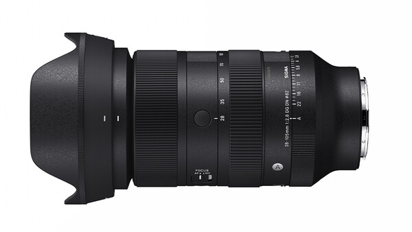 Black telephoto zoom lens with hood attached, viewed from the side against a white background.